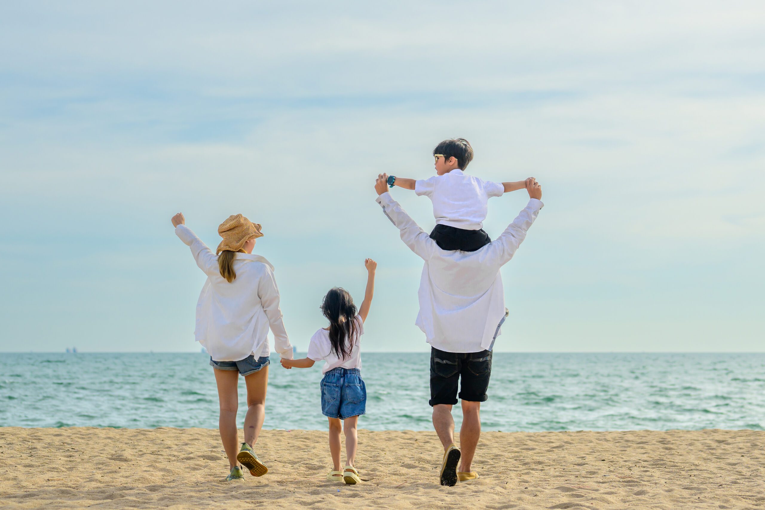 Family with beach therapy, Happy family spending time together at beach, Father give son piggyback on the beach, Travel on beach with blue sky view, Family with holiday and travel concept